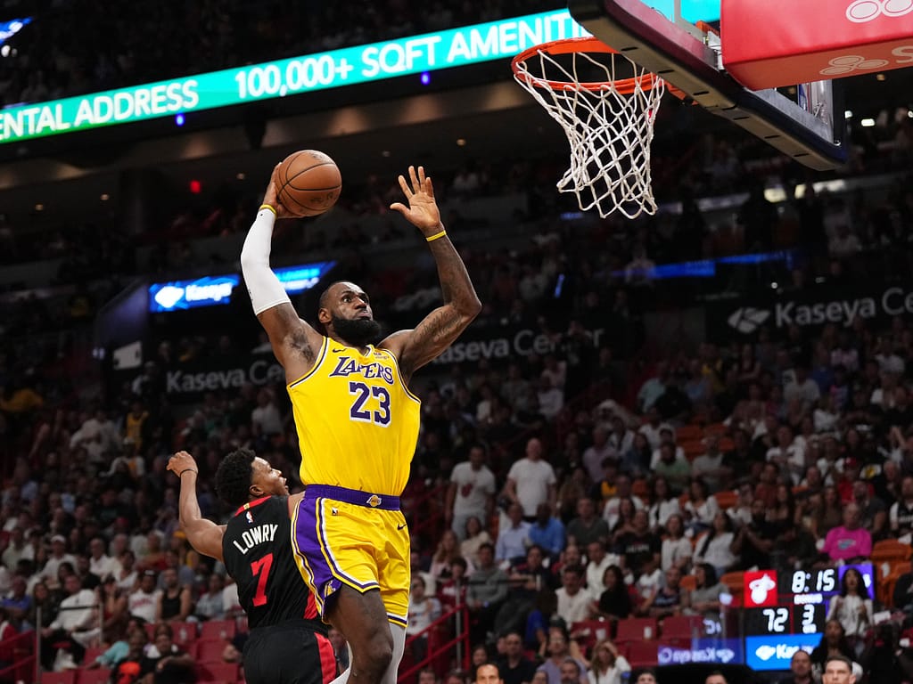 Lebron James taking a basketball dunk during a game.
